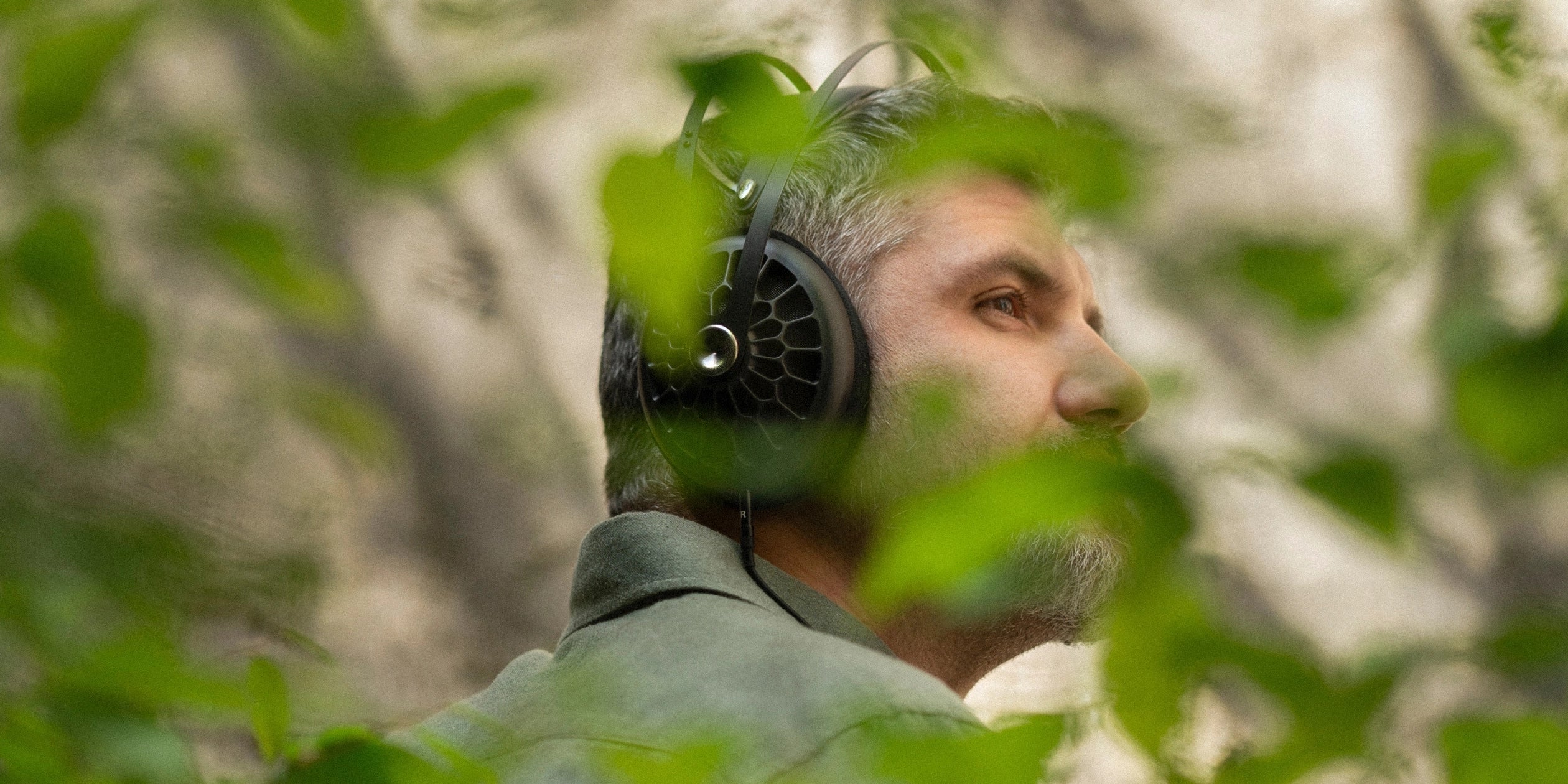 Man listening to Meze Audio 105 AER premium headphones open-back dynamic driver