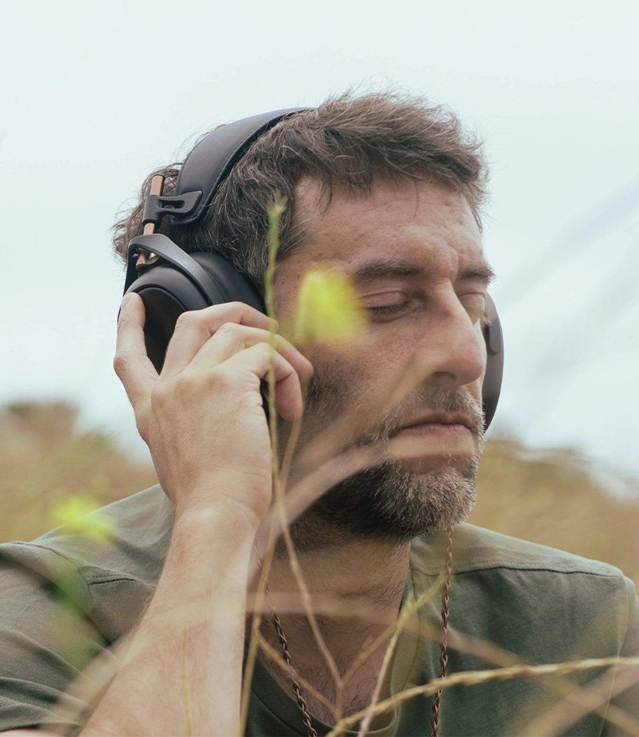 Man listening to Meze Audio closed-back planar magnetic driver Liric outdoor