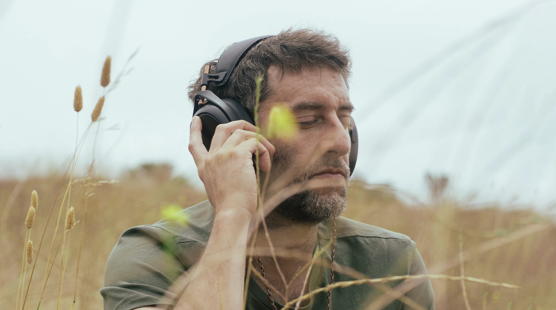 Man listening to Meze Audio Liric closed-back headphones