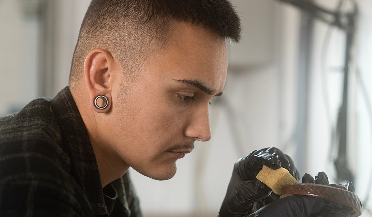 Gianluca Madotto applying linseed oil to an ear cup