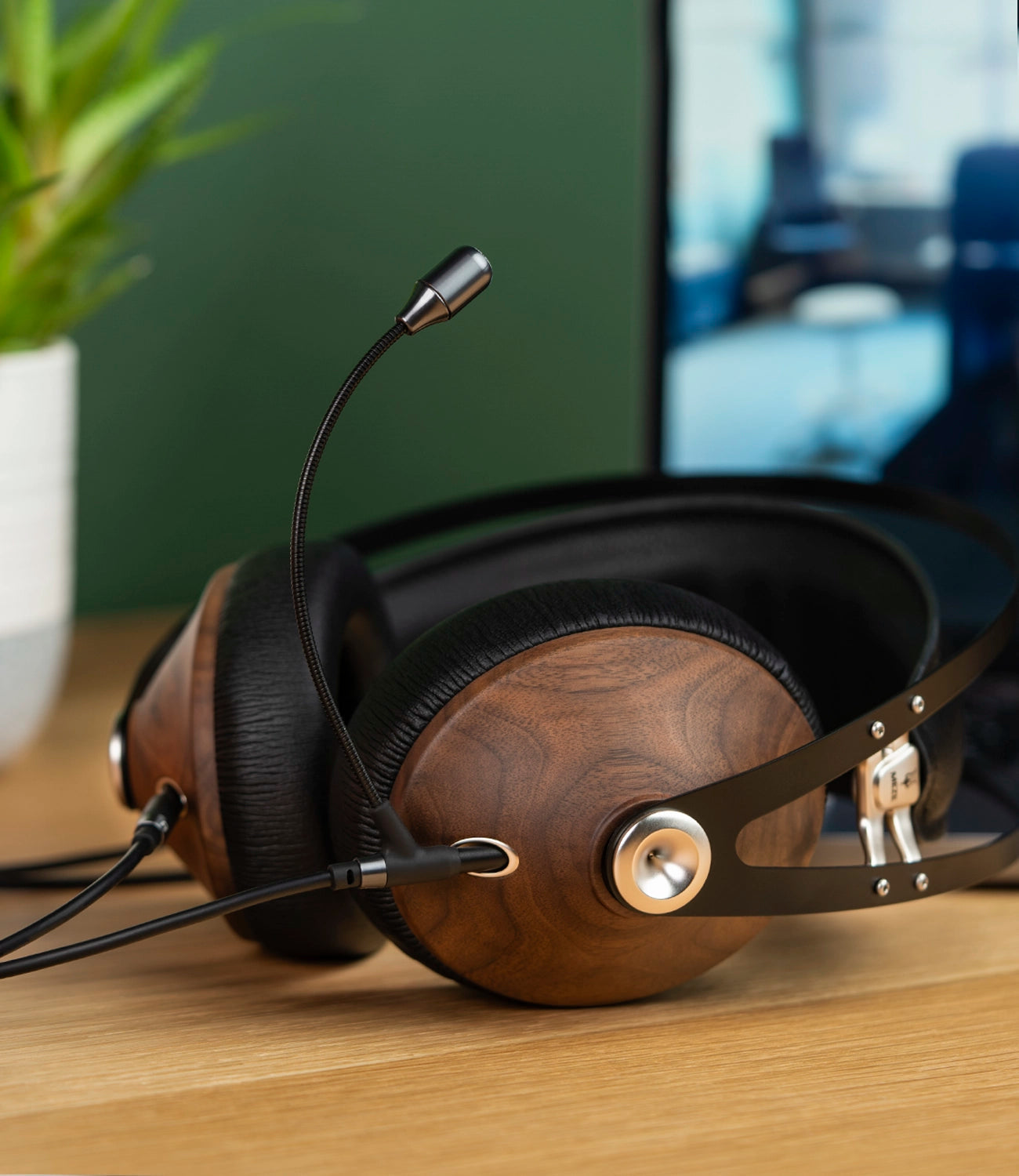 Meze Audio 99 Classics closed-back dynamic driver audiophile gaming headset resting on a wooden desk