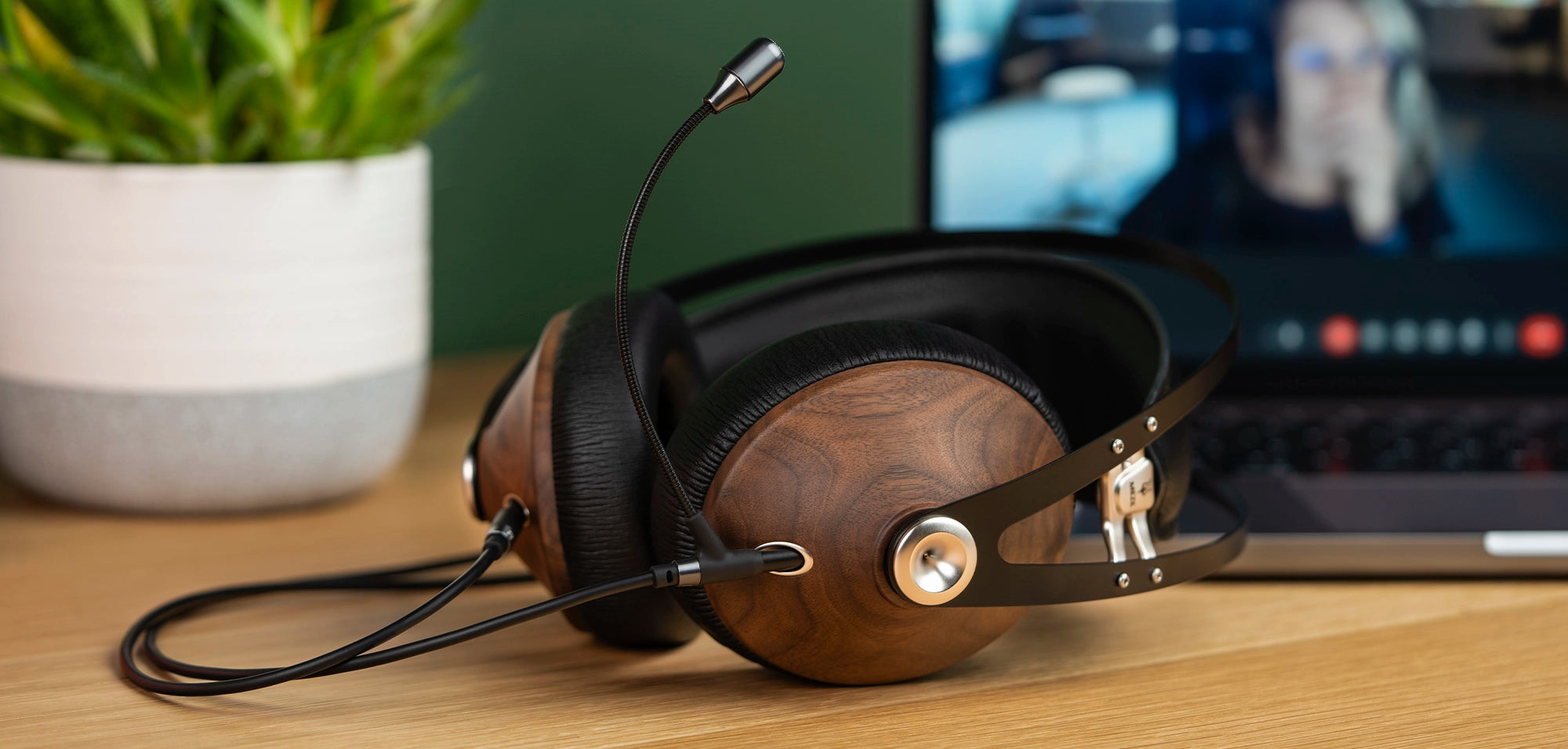 Meze Audio 99 Classics Walnut Silver dynamic driver closed-back audiophile gaming headset resting on a wooden desk