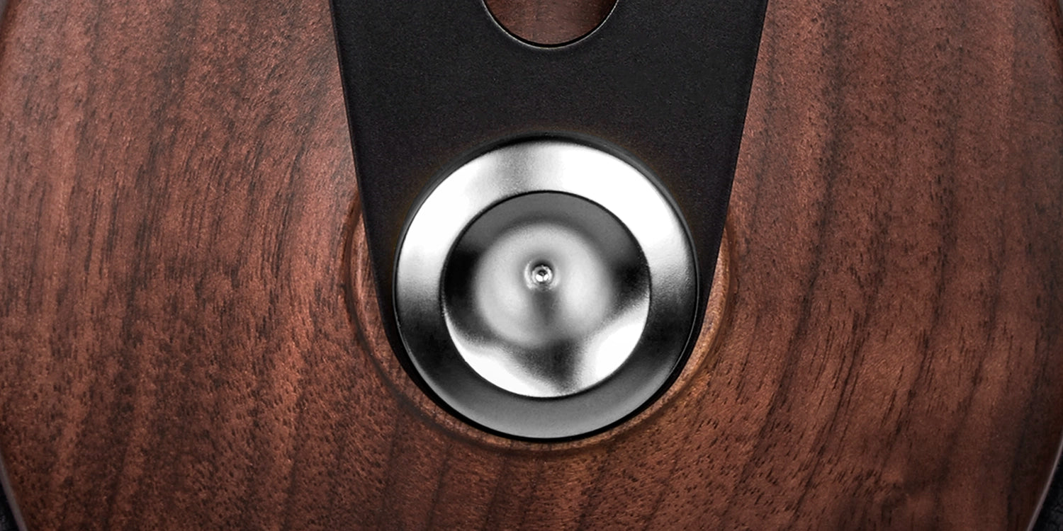 Side view highlighting the sleek walnut wood design and cushioned ear pads for immersive listening.