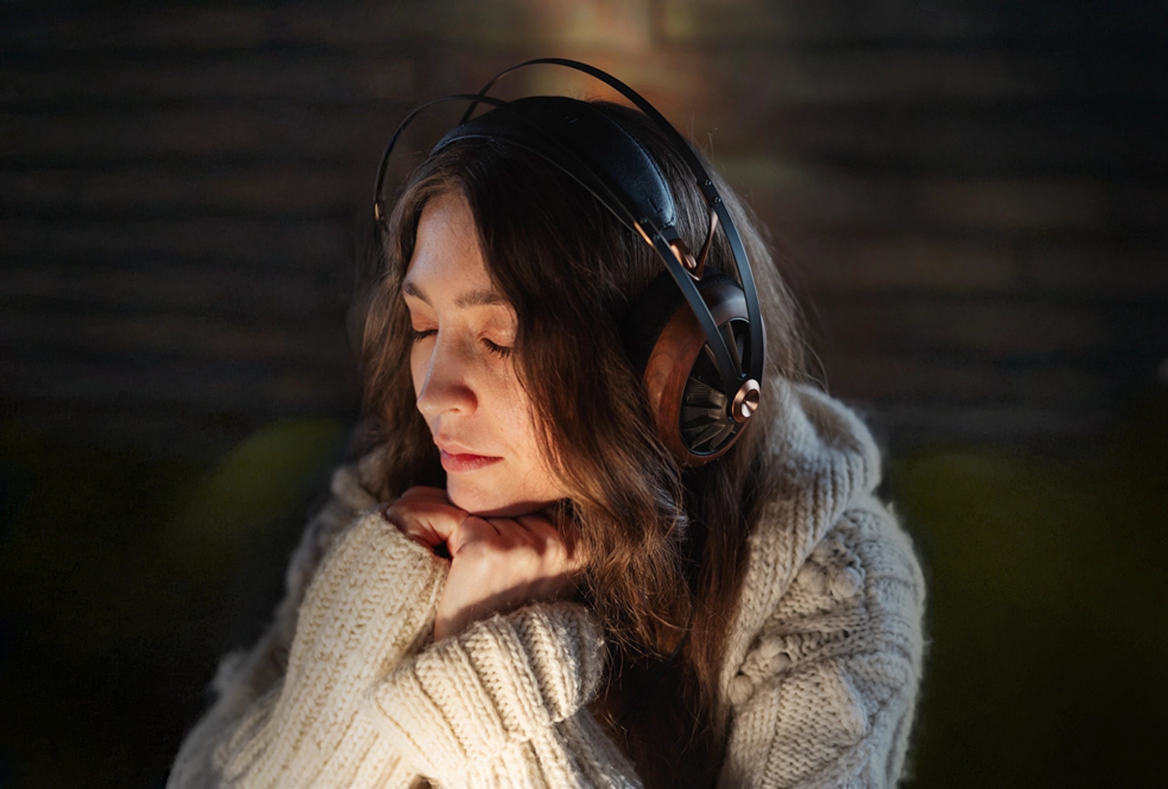 Young woman listening to premium Meze Audio open-back dynamic driver 109 PRO