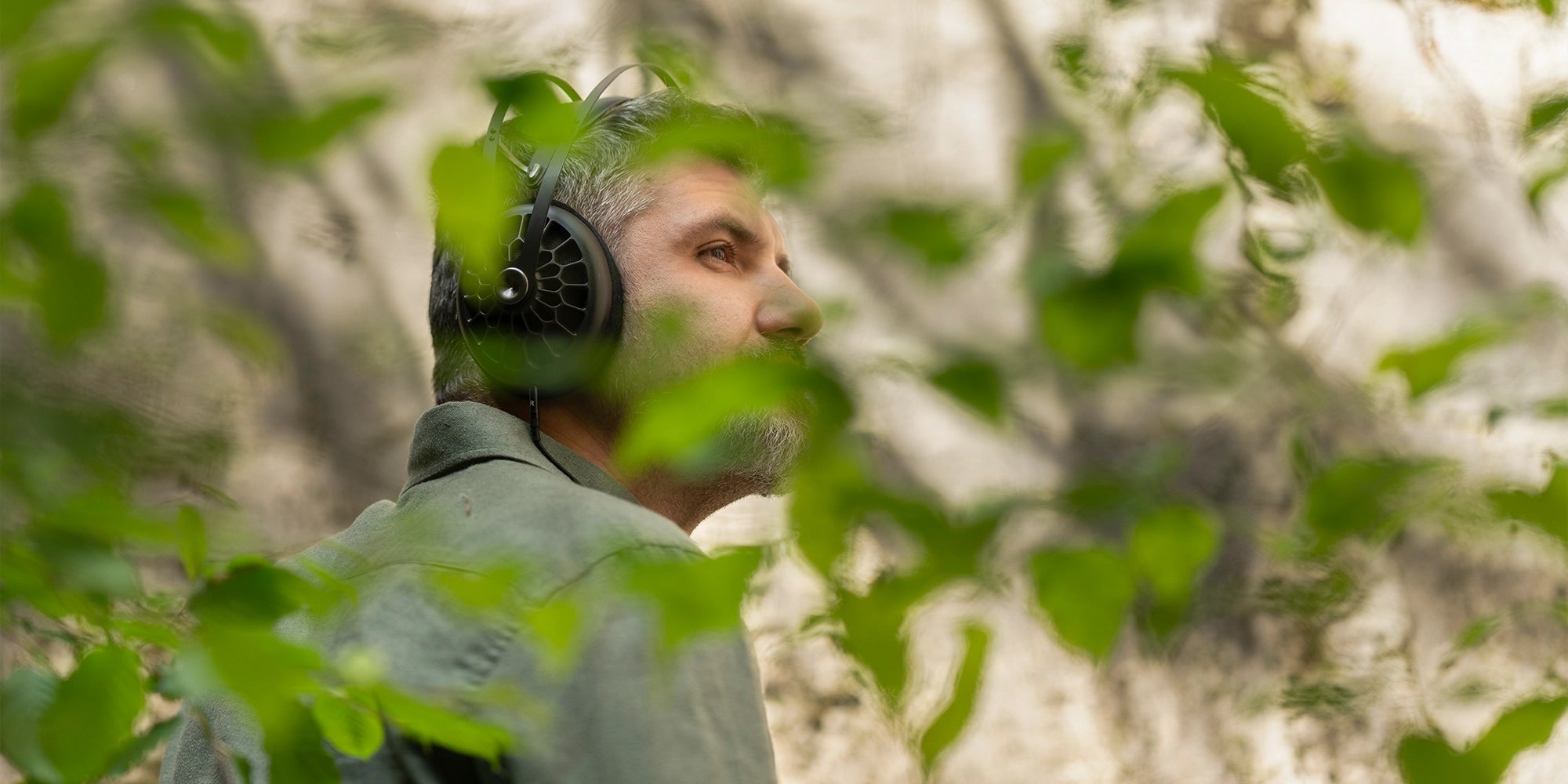 Meze Audio 99 NEO best open back high fidelity audiophile premium headphones worn by man walking in a forest