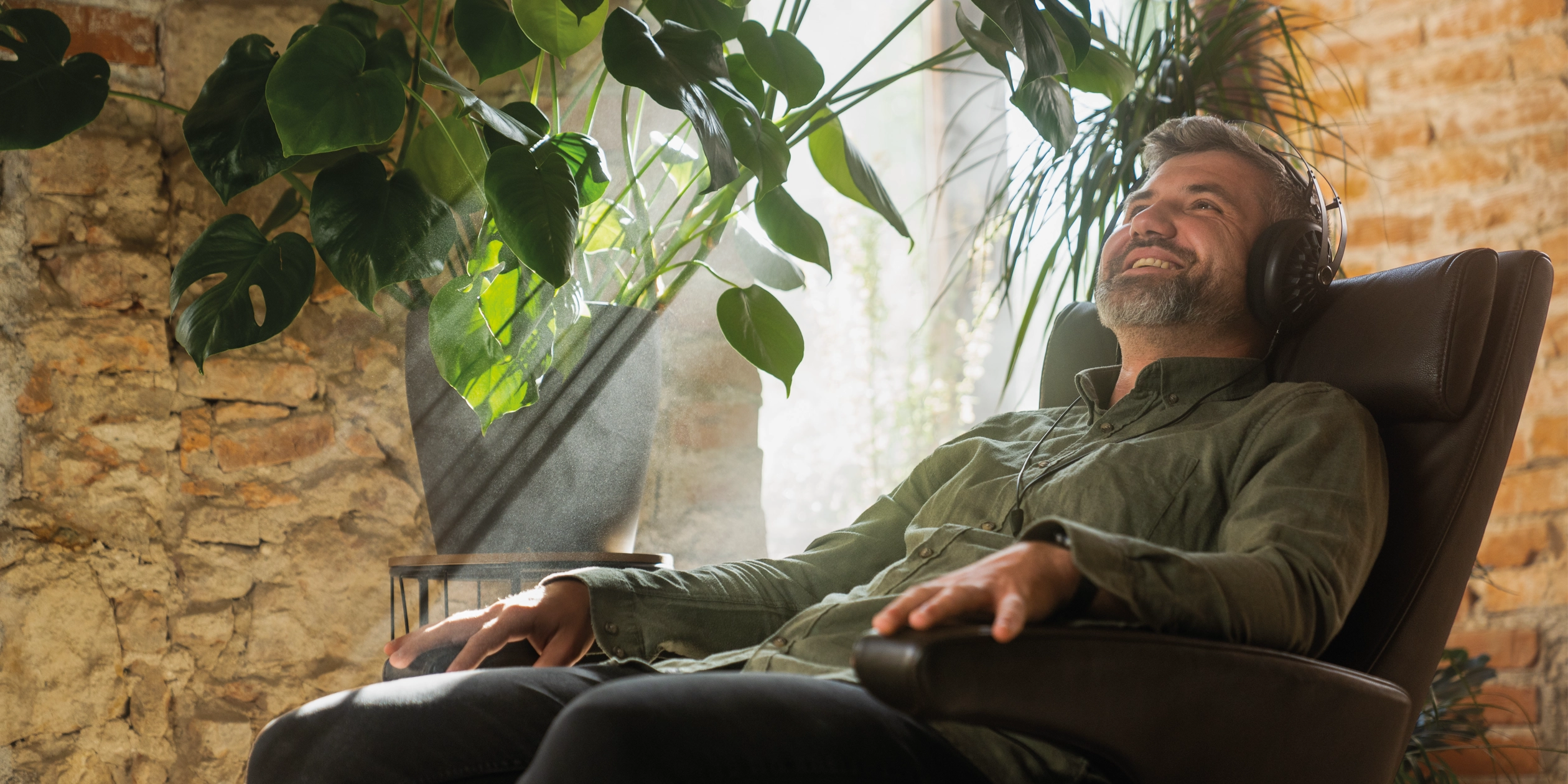 Man listening to Meze Audio 105 AER premium headphones open-back dynamic driver indoors