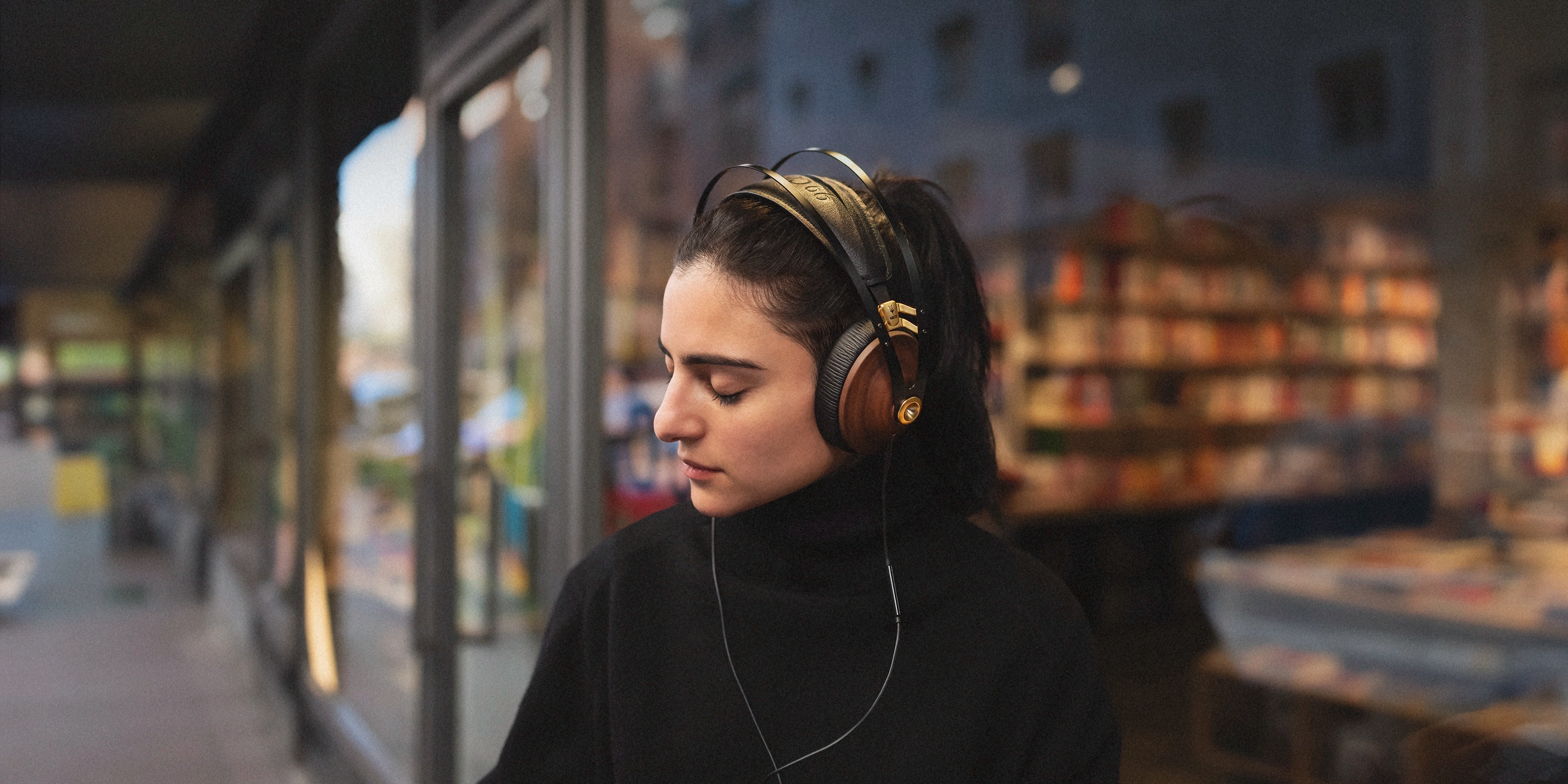 Premium closed-back audiophile headphones with walnut wood ear cups, highlighting high-fidelity sound and luxurious design for music enthusiasts.