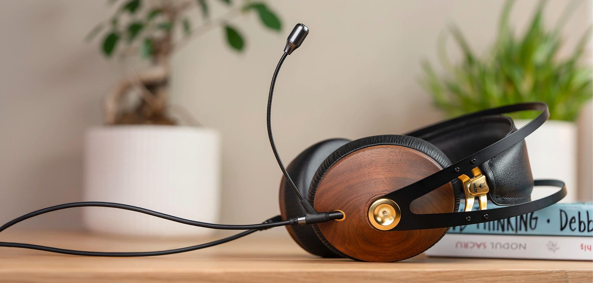 Meze Audio 99 Classics closed-back dynamic driver audiophile gaming headset resting on a wooden desk