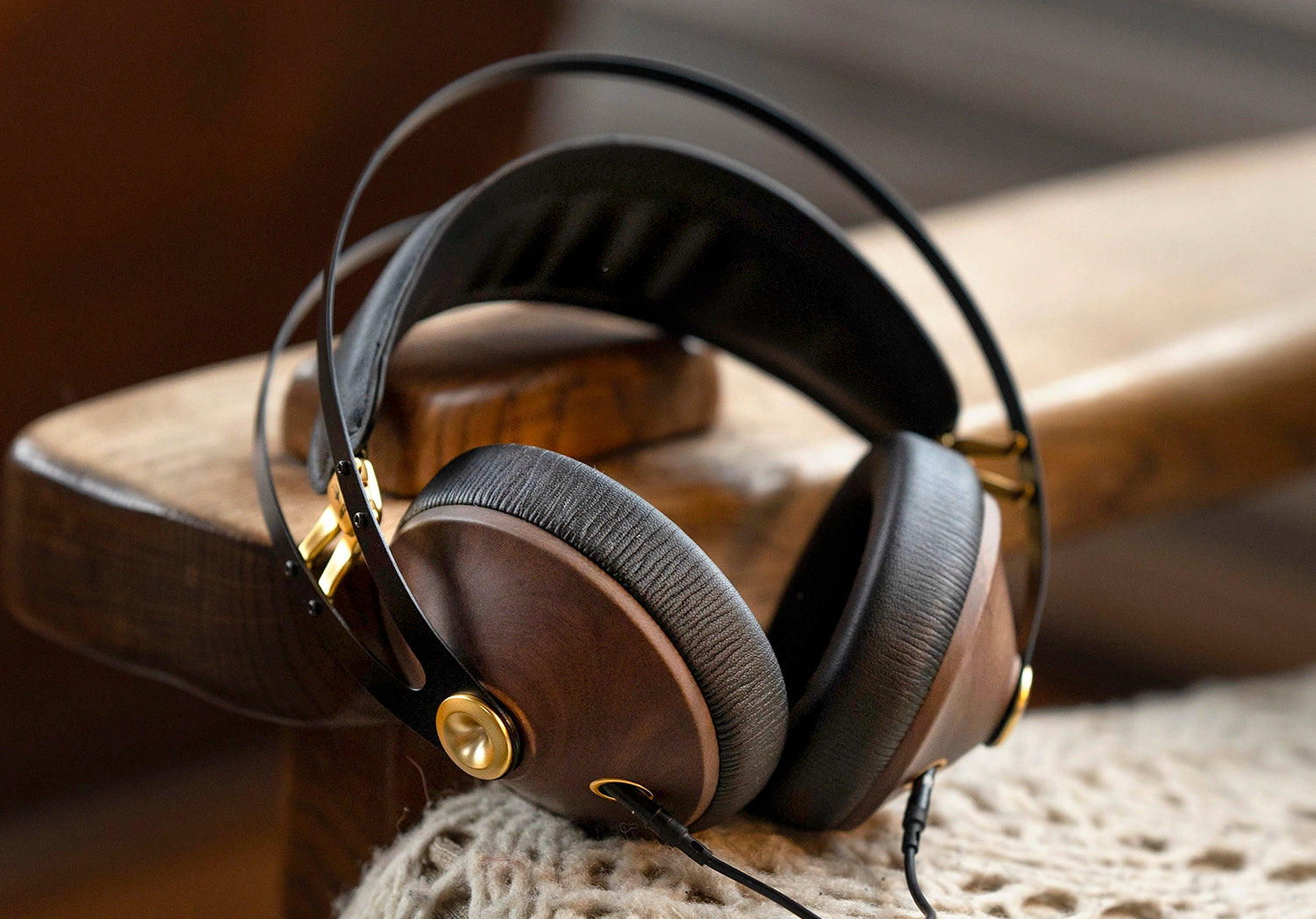 Meze Audio 99 Classics closed back audiophile headphones lateral view on a wooden chair