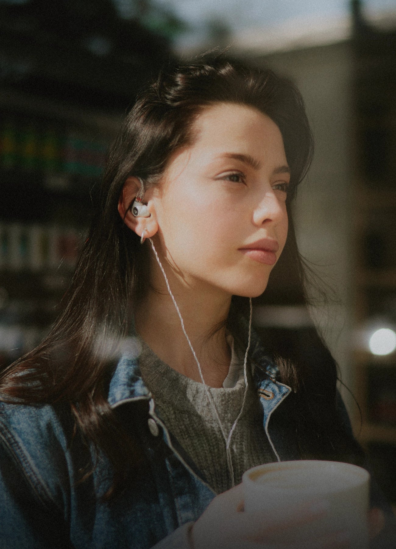 Young woman wearing the Meze Audio Alba best wired earbud headphones