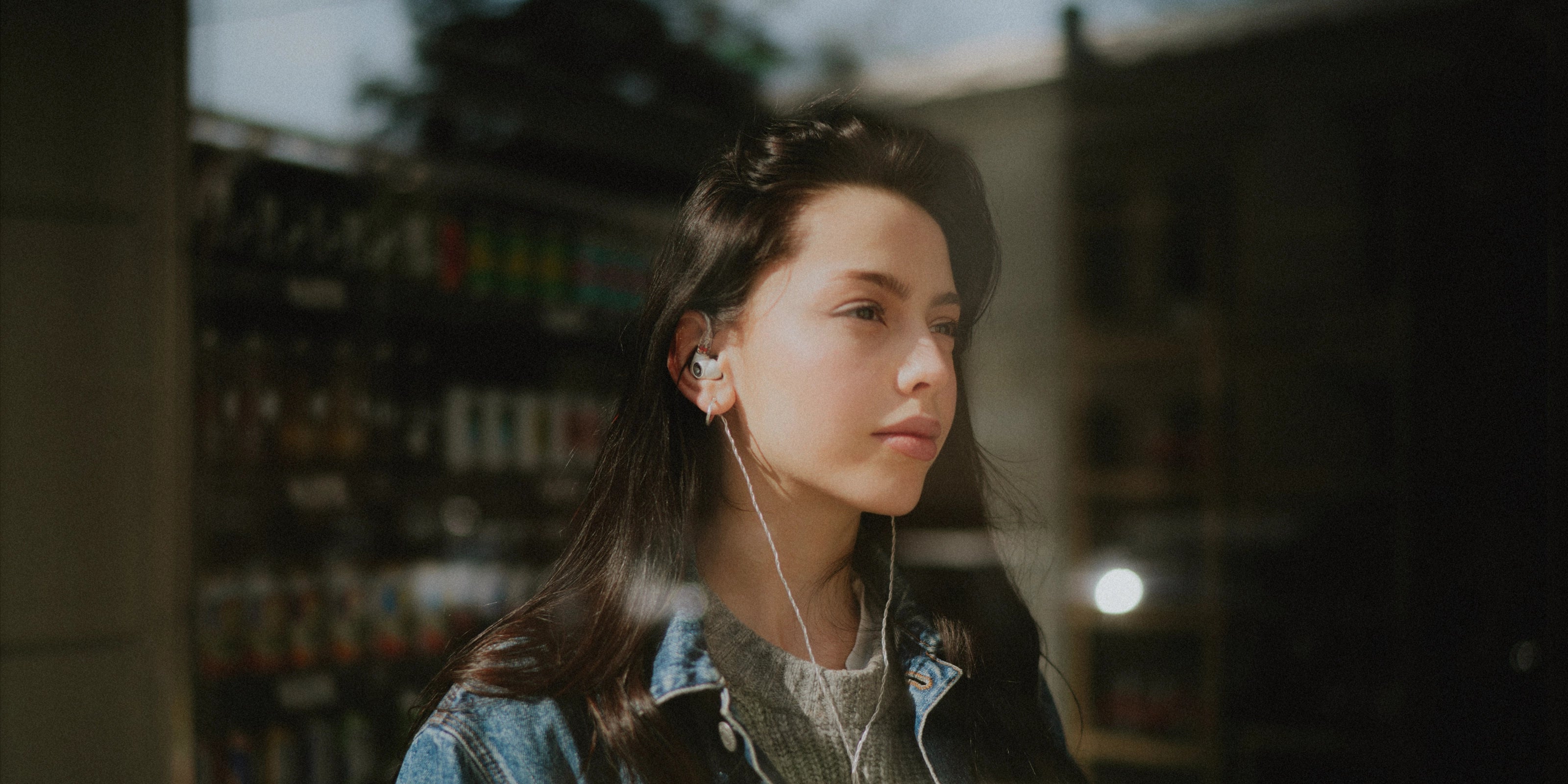 Young woman wearing the Meze Audio Alba best wired earbud headphones