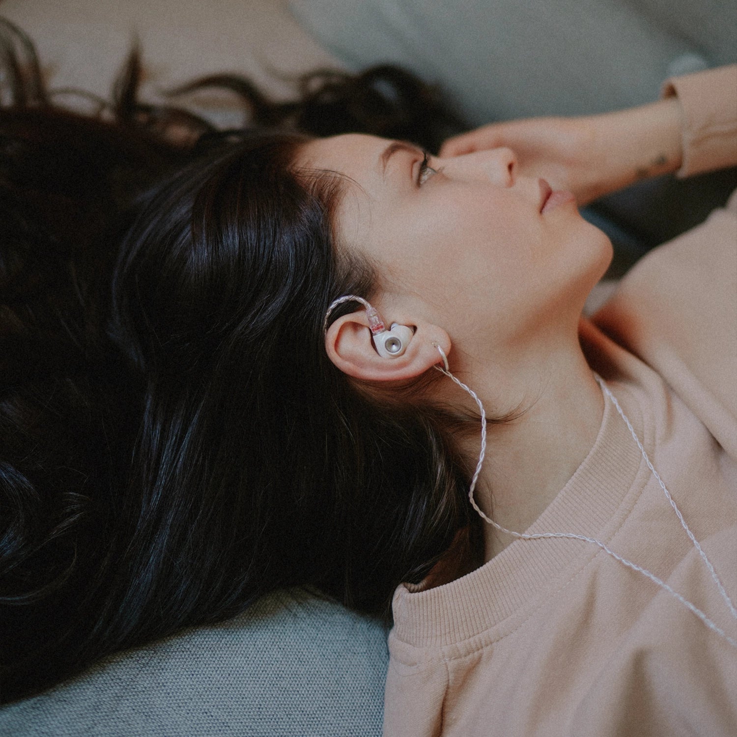 Meze Audio Alba in ear headphones worn by a girl while in bed