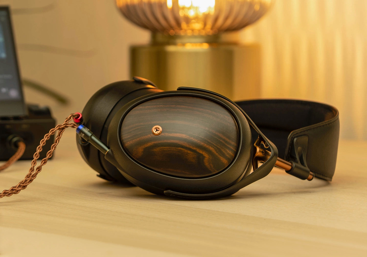 Meze Audio Liric Second Gen planar magnetic audiophile closed back headphones on a wooden desk