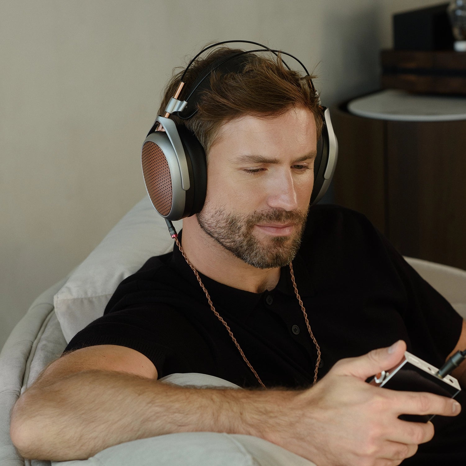 Man listening to Meze Audio POET premium built open-back planar magnetic driver headphones 