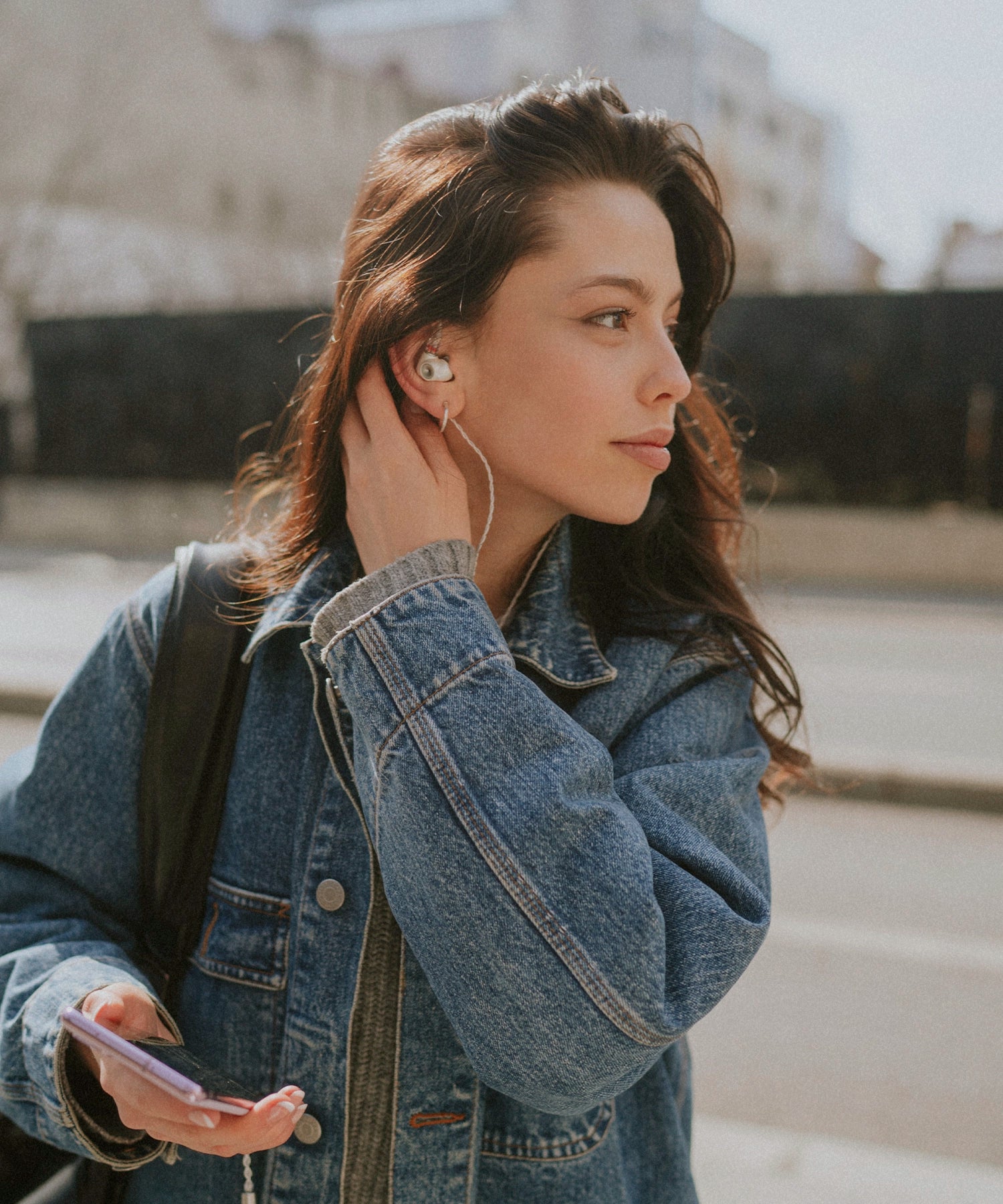 Young woman using the Meze Audio Alba dynamic driver audiophile in-ear wired earbuds