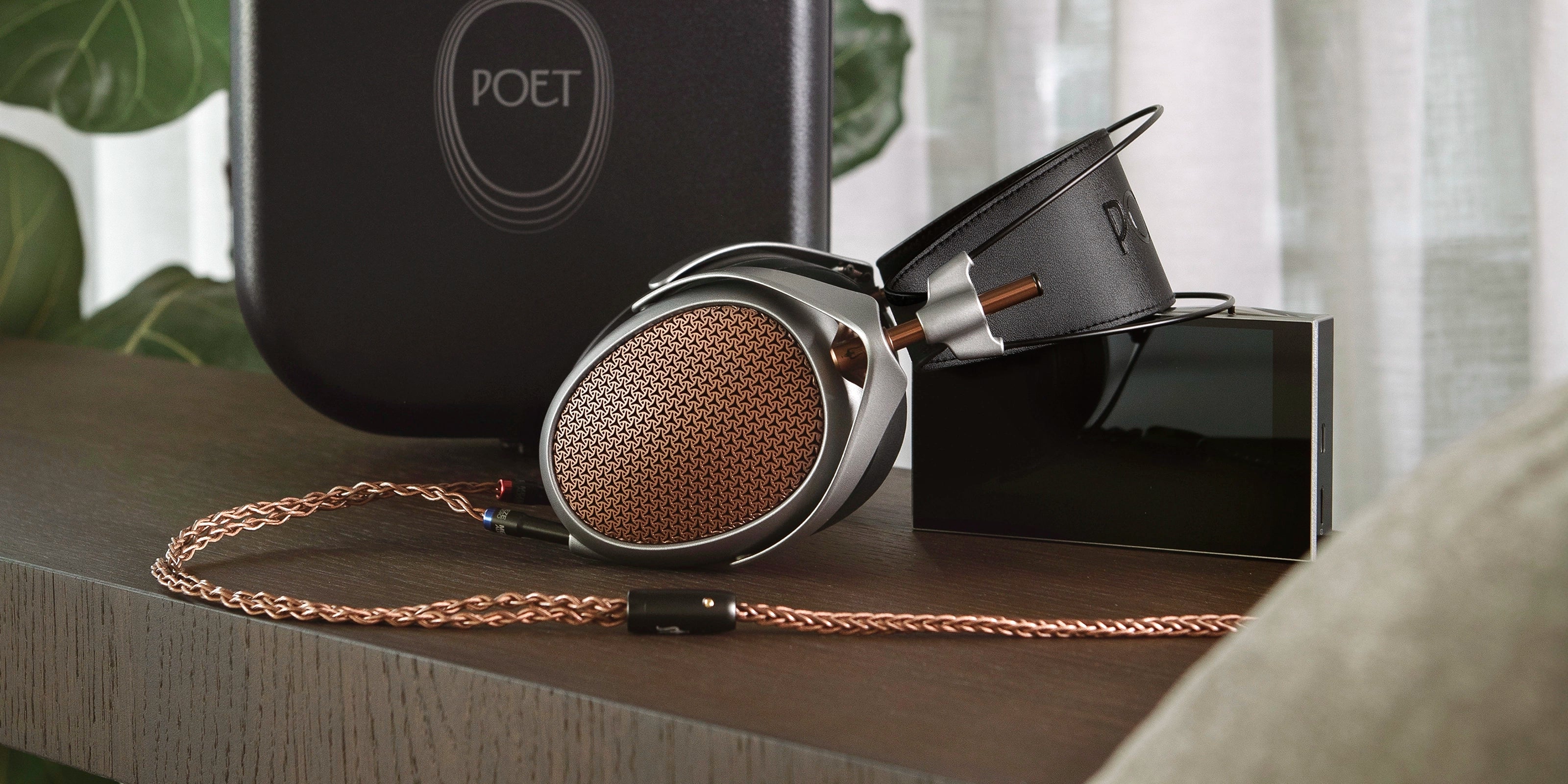 Meze Audio POET premium built open-back planar magnetic driver headphones sitting on table with AMP